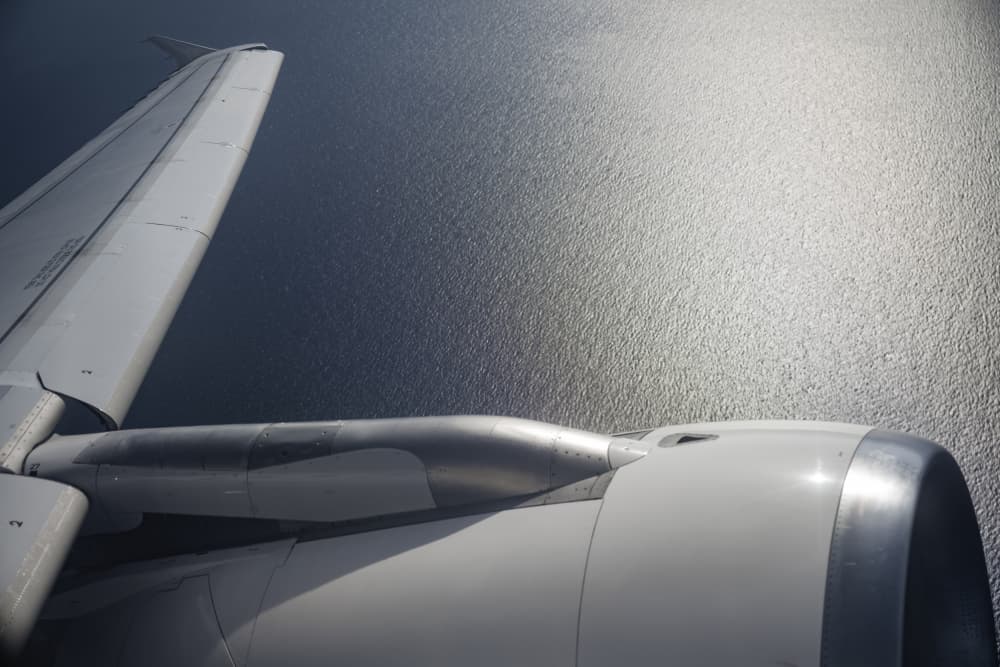 Wing View Sparkling Ocean by Tal Paz-Fridman — canvas wall art