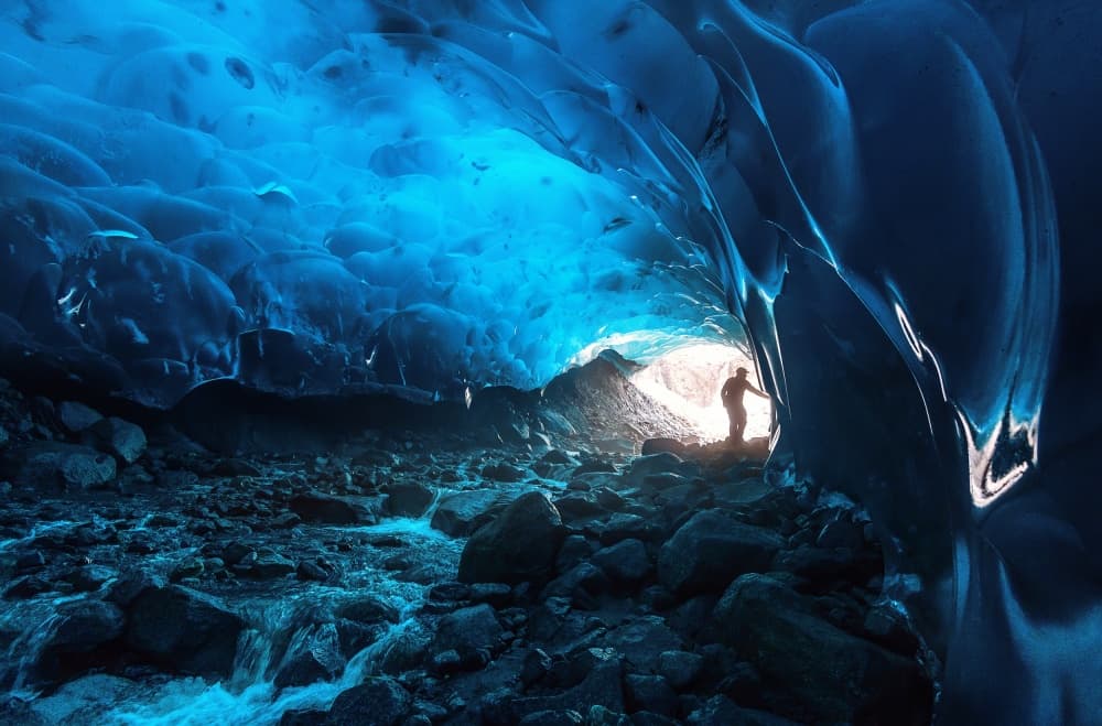 Blue Ice Cave Explorer by Naphat Chantaravisoot — canvas wall art