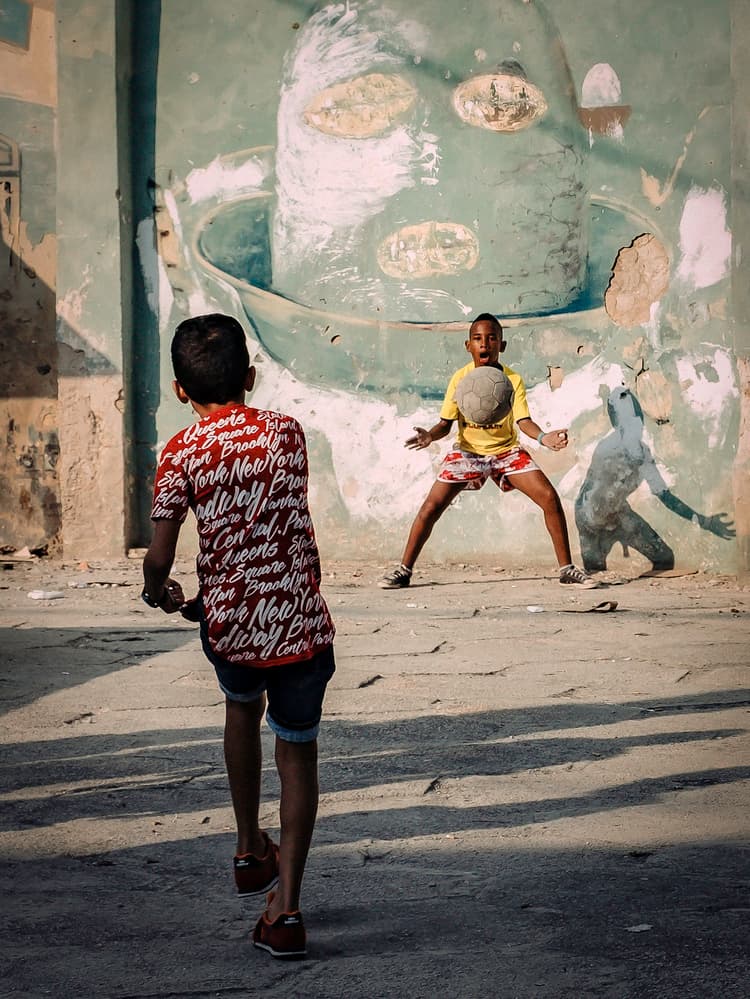 Boys Playing Football by Andy Bauer — canvas wall art