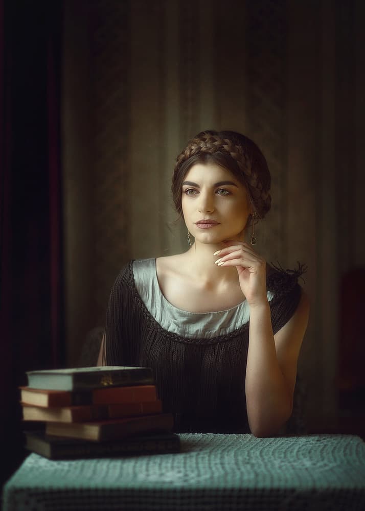 Thoughtful Woman with Books by Raluca Arhire — canvas wall art
