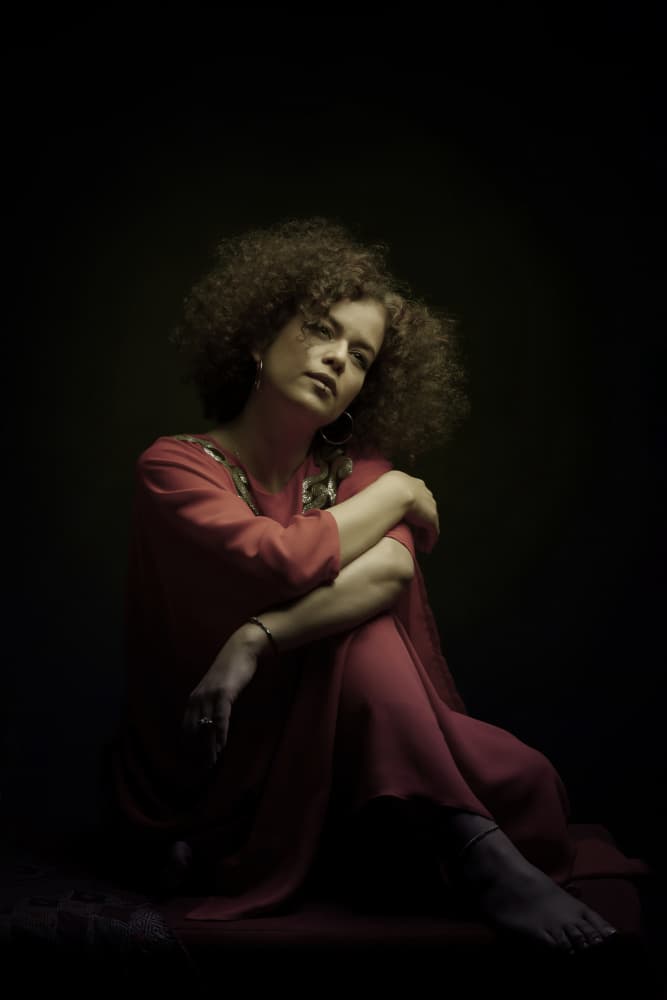 Pensive Woman Red Dress by Moein Hasheminasab — canvas wall art