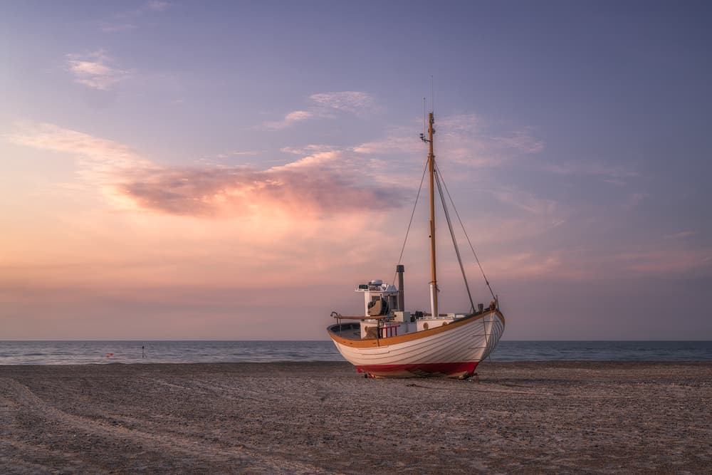 Beached Boat Sunset Glow by Ludwig Riml — canvas wall art