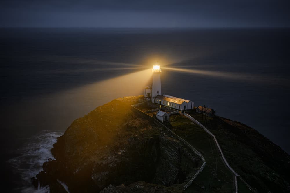 Guiding Lighthouse At Night by Chris Latham — canvas wall art