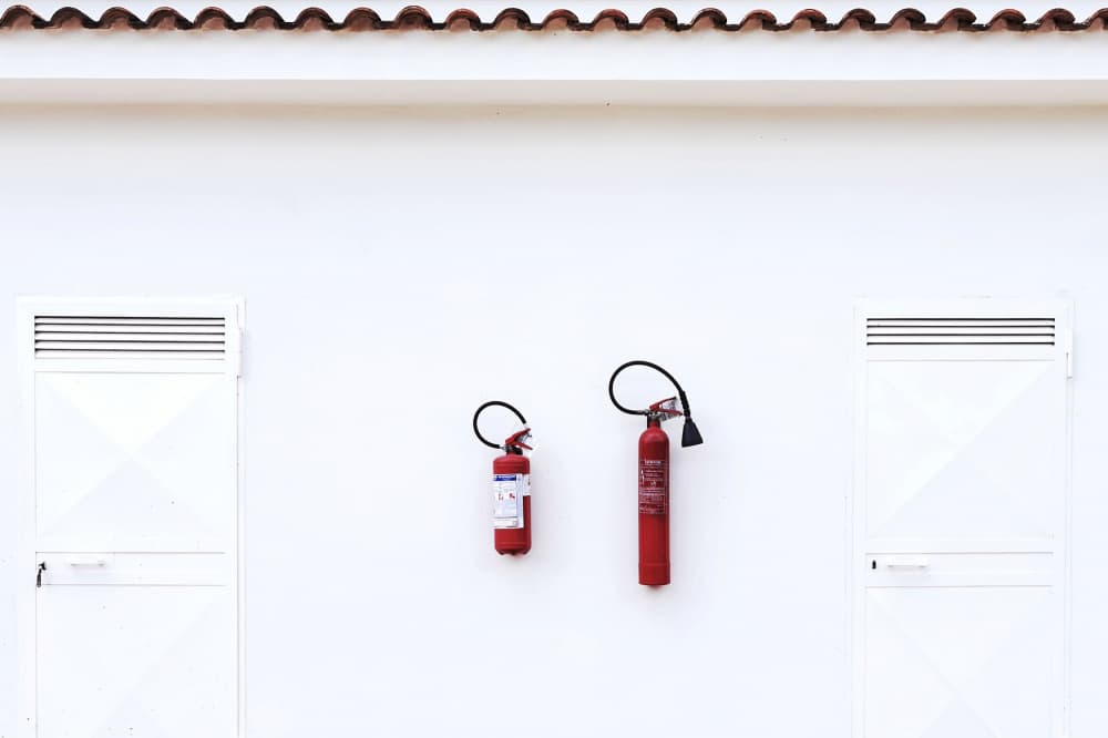 Red Fire Extinguishers by Branko Markovic — canvas wall art