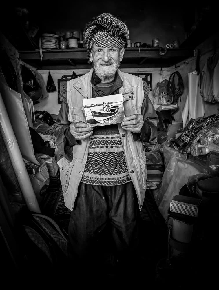 Smiling Elder's Boat Photo by Bashar Alsofey — canvas wall art