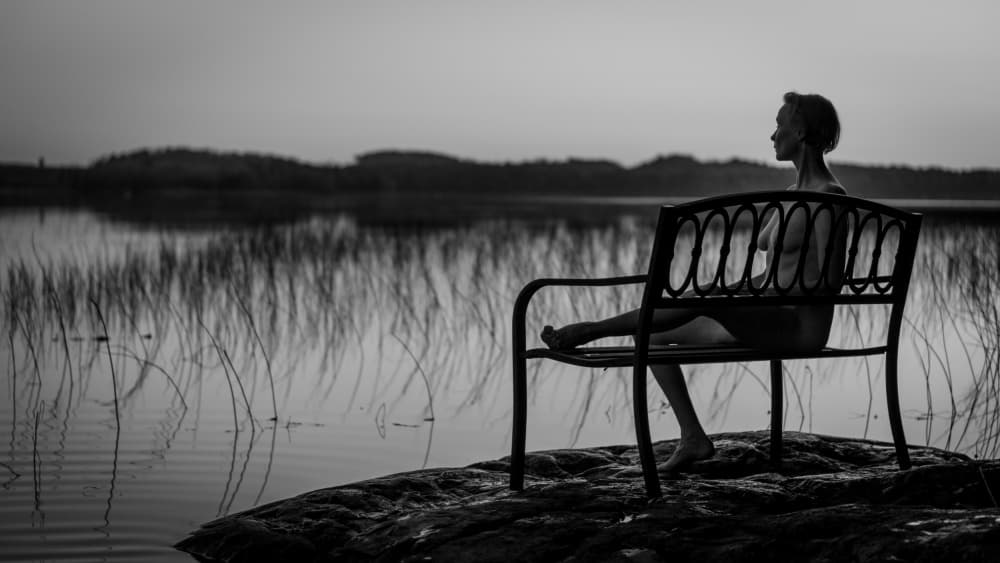 Serene Woman Lakeside Bench by Jani Hotakainen — canvas wall art