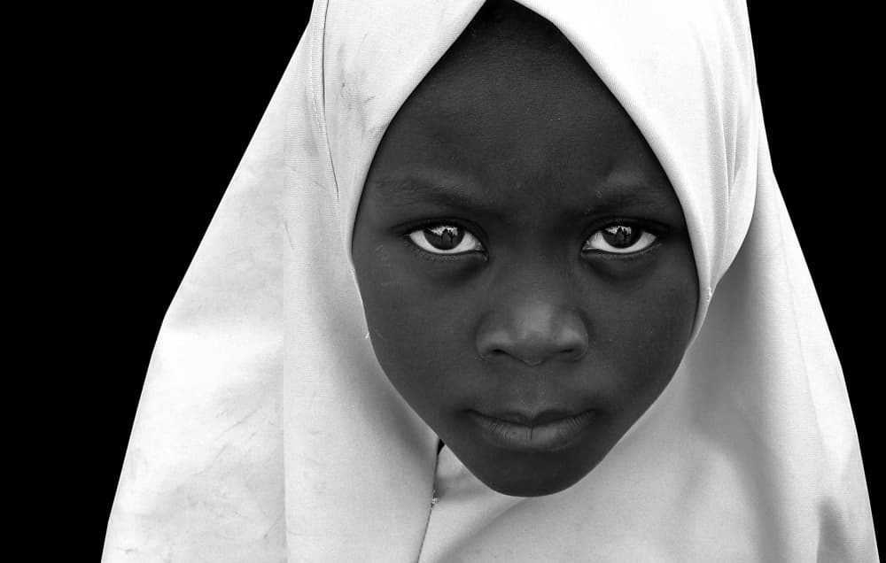 Young Girl's Intense Gaze by Irene Perovich — canvas wall art