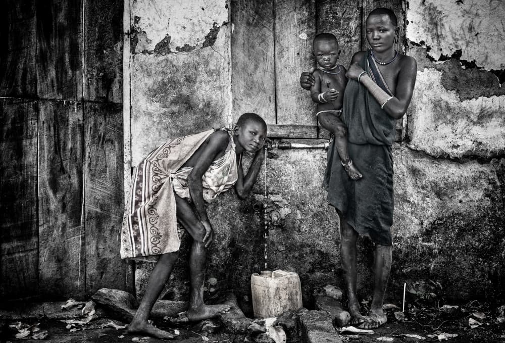 African Village Water Life by Joxe Inazio Kuesta Garmendia — canvas wall art
