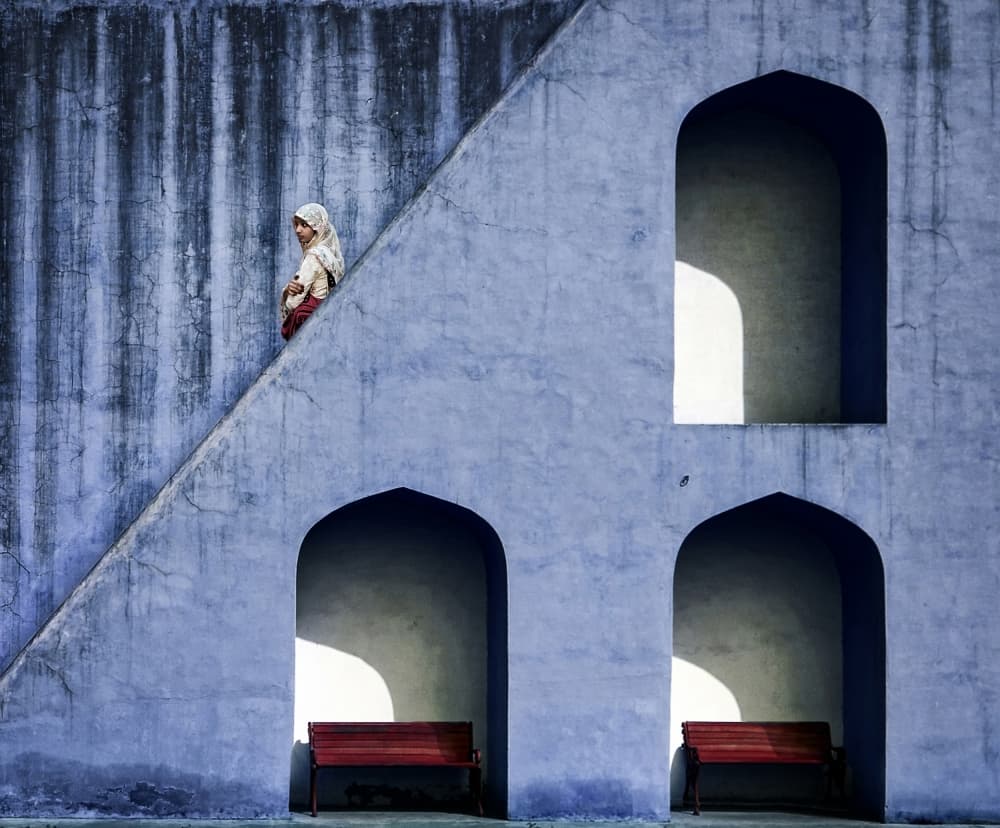 Woman Ascending Blue Wall by Piet Flour — canvas wall art