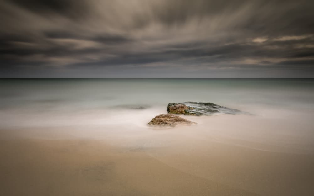 Moody Beach Rocks by Rico Cavallo — canvas wall art