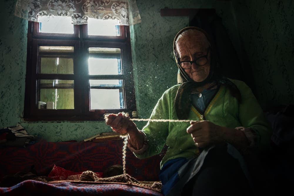 Old Hands Spinning Wool by Faris Saieda — canvas wall art