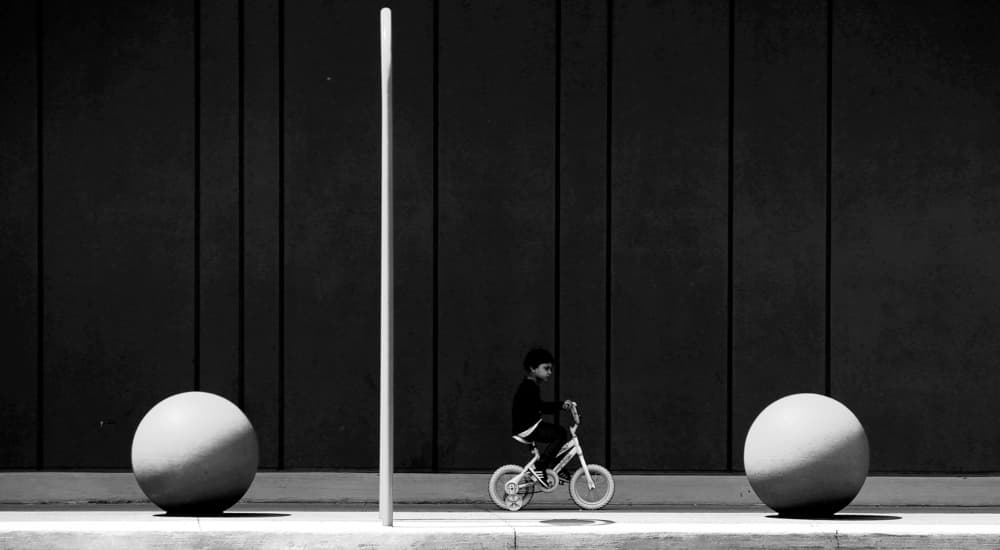 Boy Riding Among Spheres by Jian Wang — canvas wall art