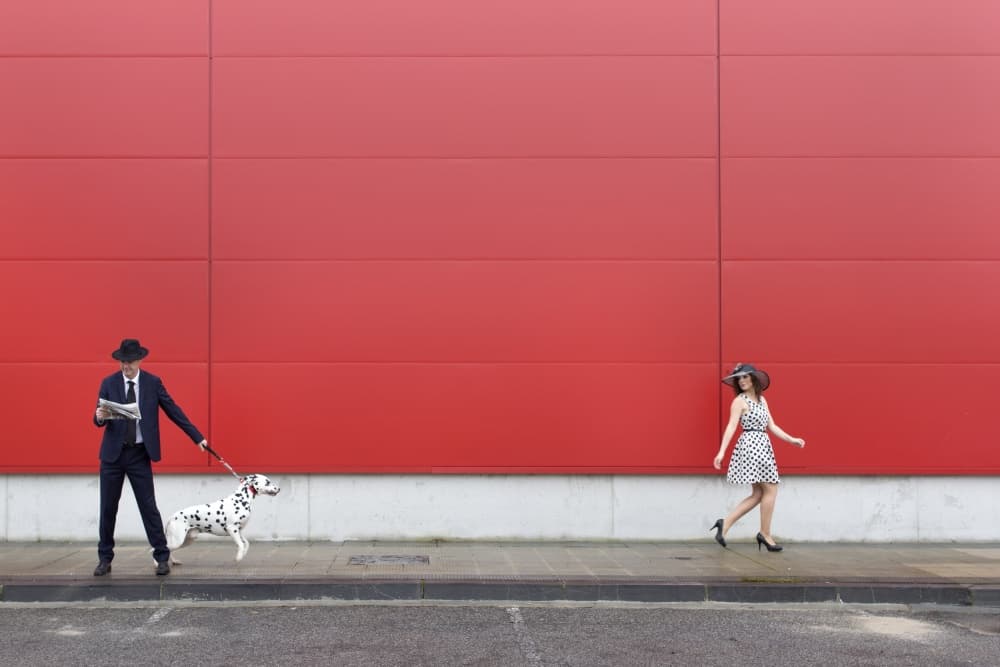 Red Wall City Stroll by Kike Balenzategui — canvas wall art