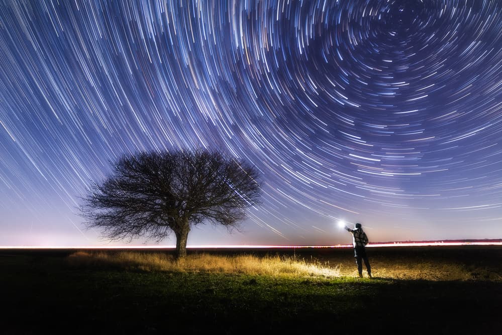 Star Trails Over Dark Field by Andrei Ionut Dascalu — canvas wall art