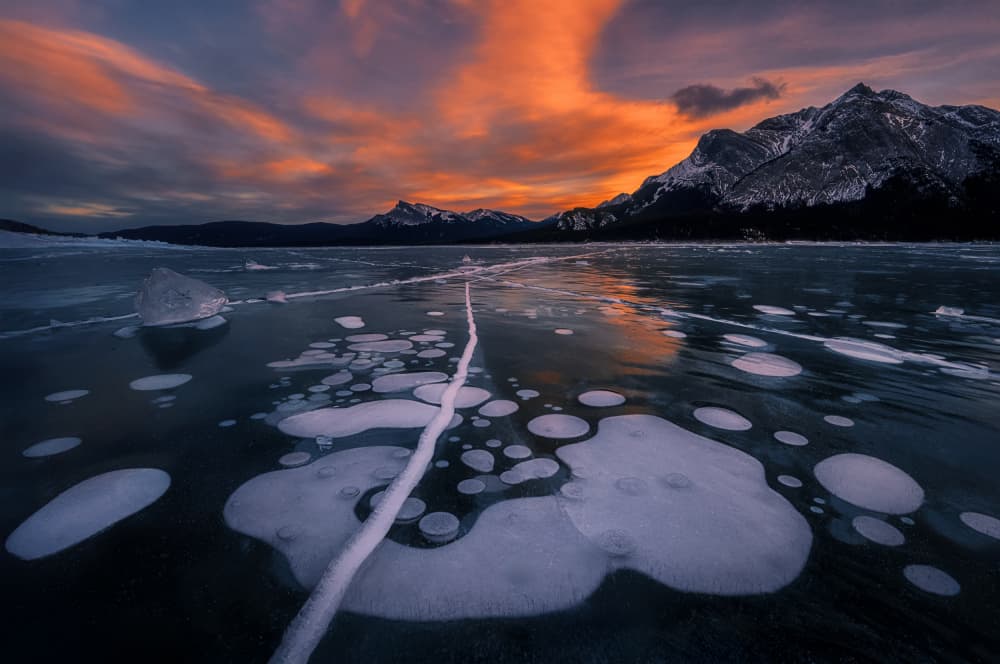 Frozen Lake Sunset Bubbles by Lydia Jacobs — canvas wall art
