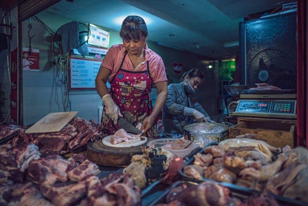 Market Butcher Preparing Meat by Marco Tagliarino — canvas wall art