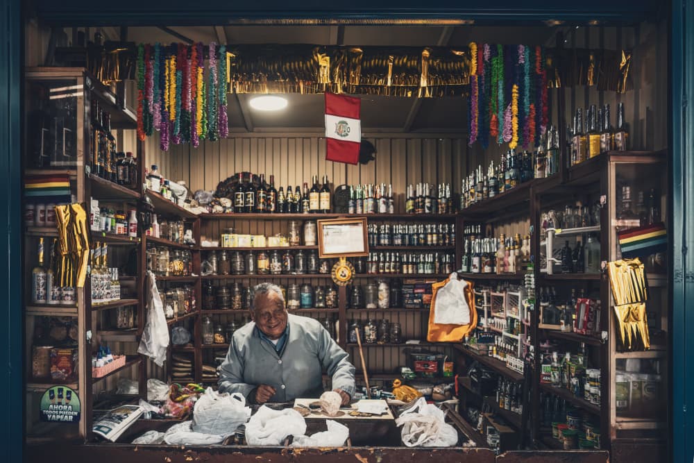 Peruvian Shopkeeper's Smile by Marco Tagliarino — canvas wall art