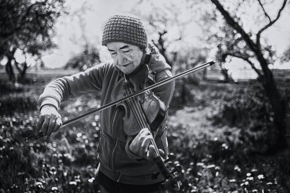 Serene Violinist Outdoors by Normunds Kaprano — canvas wall art