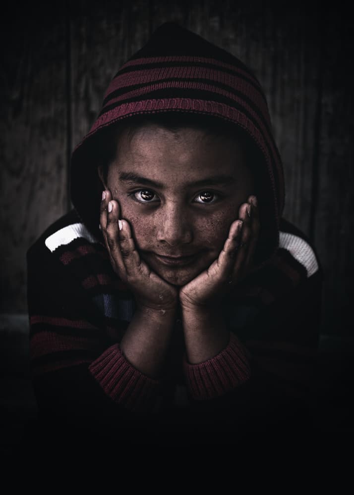 Boy's Soulful Gaze by Marco Tagliarino — canvas wall art