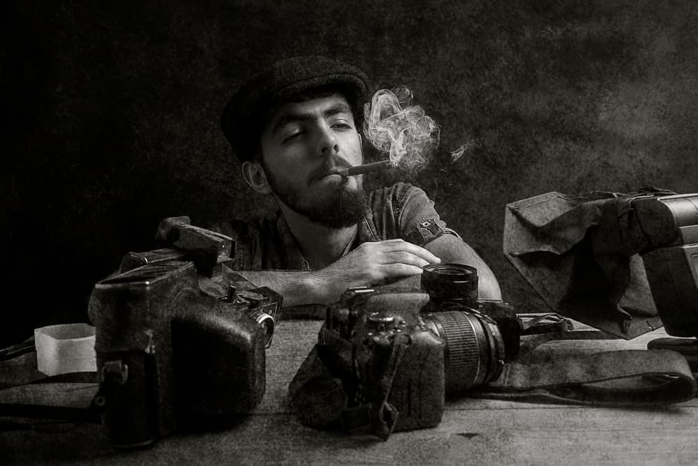 Thoughtful Photographer Smoking Cigar by Ali Bader — canvas wall art