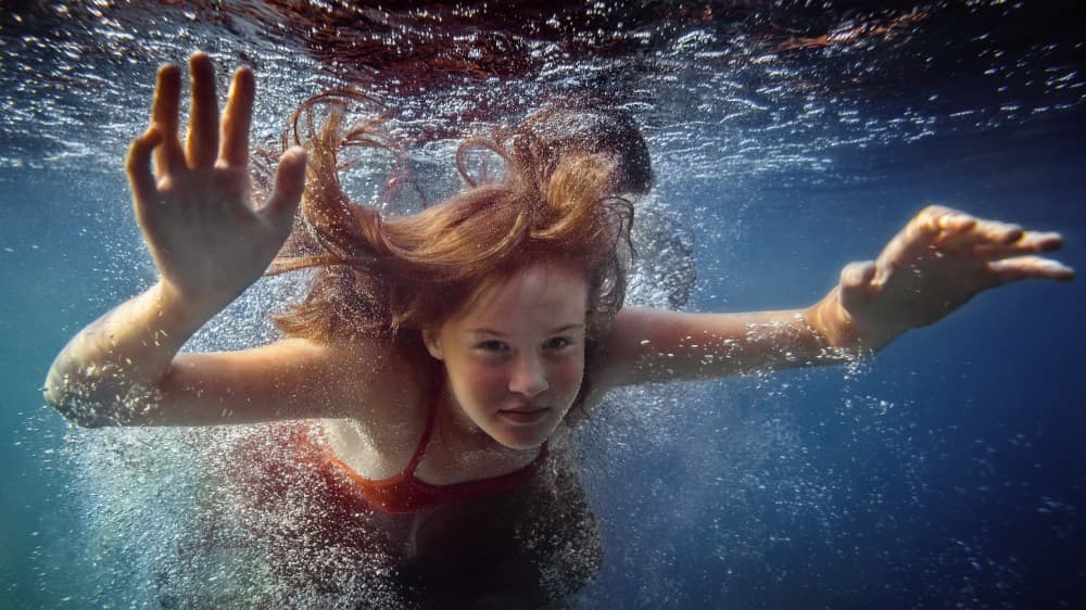Playful Underwater Swim by Dmitry Frizel — canvas wall art