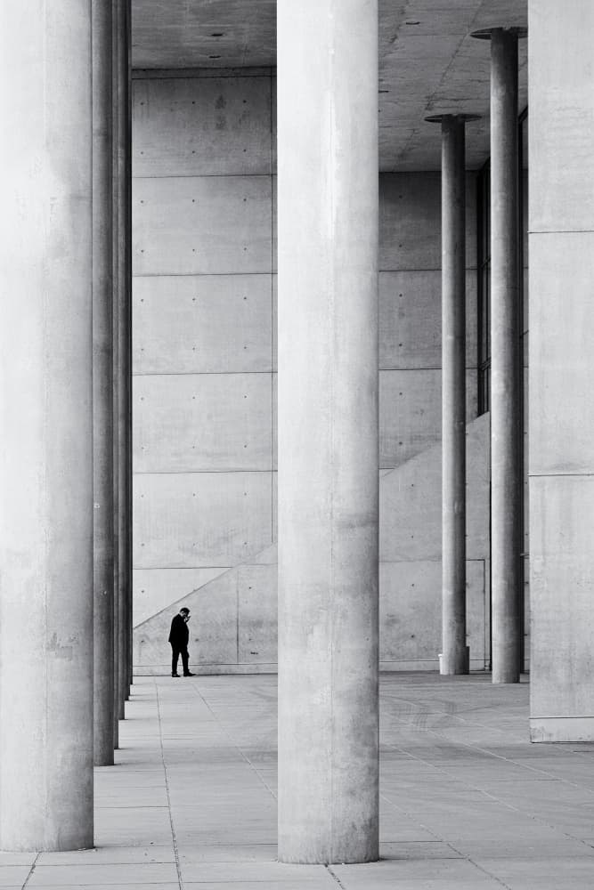Man Among Concrete Columns by Elena Raceala — canvas wall art