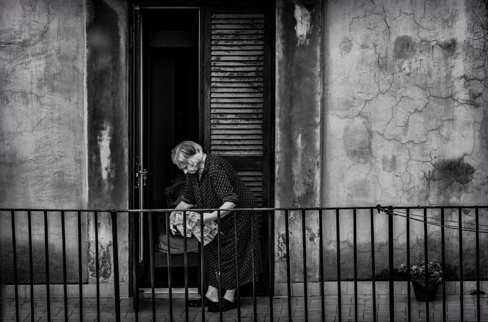 Elderly Woman's Quiet Balcony by Ömer Ates Kızıltug — canvas wall art