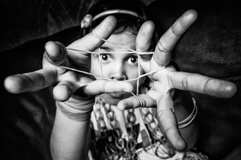 Curious Child With Rubber Bands by Arief Siswandhono — canvas wall art