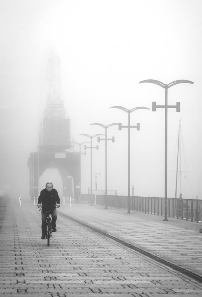 Man Biking Through Fog by Anna Niemiec — canvas wall art
