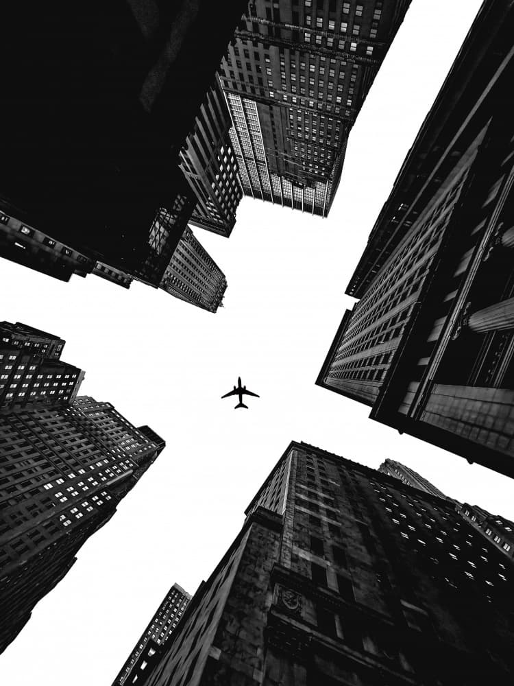 Airplane Over City by Emma Zhao — canvas wall art