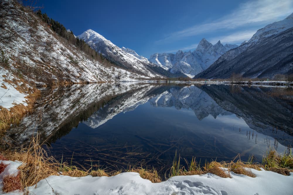Snowy Mountain Lake Reflection by Arsen Alaberdov — canvas wall art