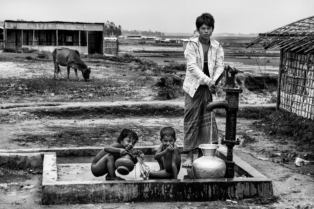 Children Pumping Water by Joxe Inazio Kuesta Garmendia — canvas wall art