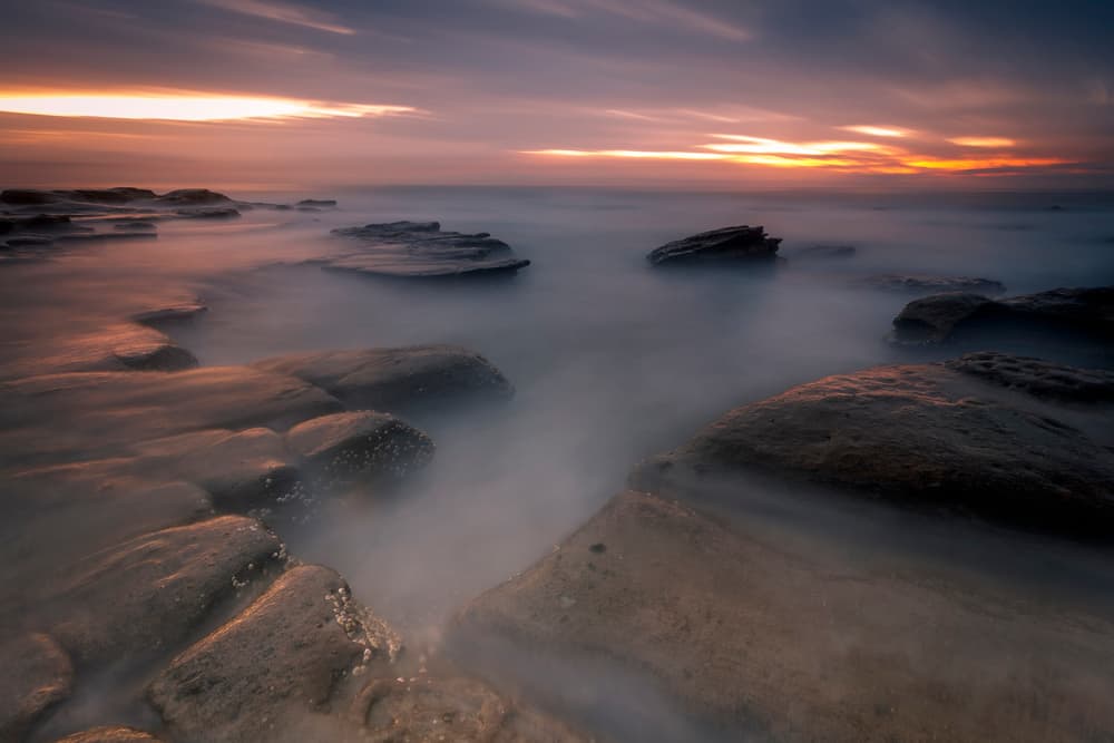 Misty Coastal Sunset by Christopher Perez Liedl — canvas wall art