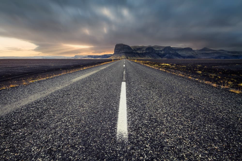 Empty Road To Mountains by Carlos M. Almagro — canvas wall art