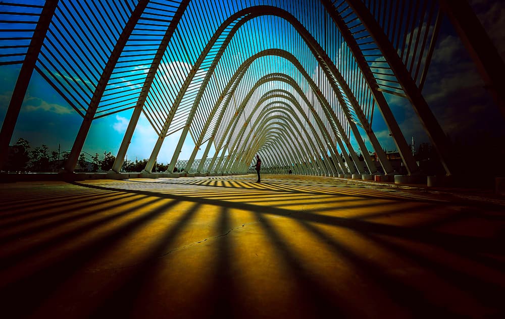 Solitary Figure Under Arches by RABIA BASHA ARTIST — canvas wall art