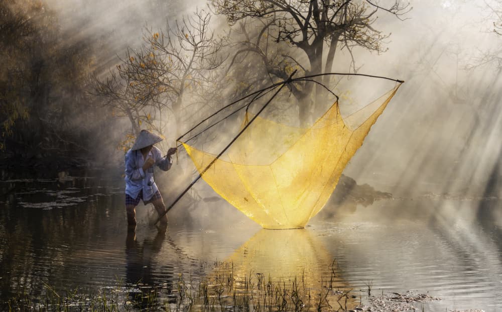 Misty River Fisherman by Nguyen Tan Tuan — canvas wall art