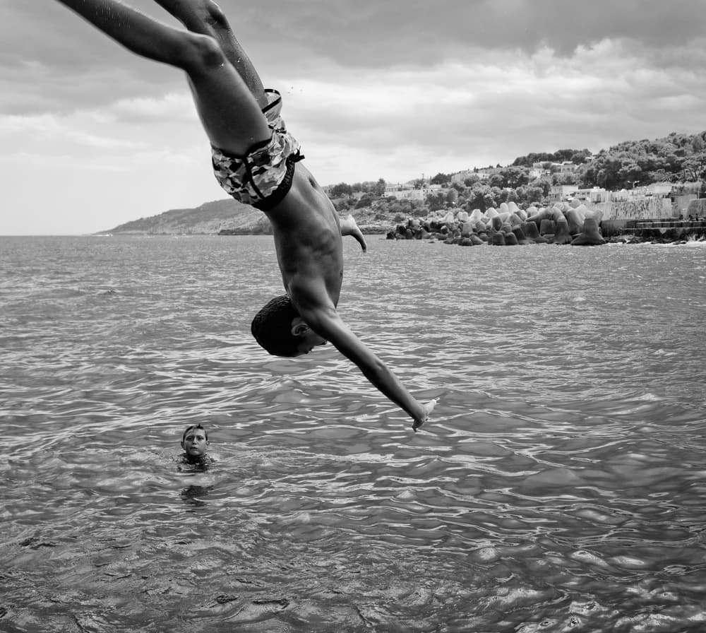 Boy Diving into Ocean by Lorenzo Grifantini — canvas wall art