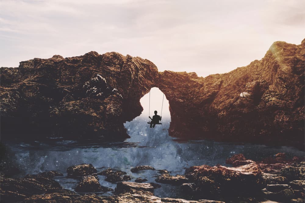 Swinging Under Natural Arch by Emiliano Deificus — canvas wall art