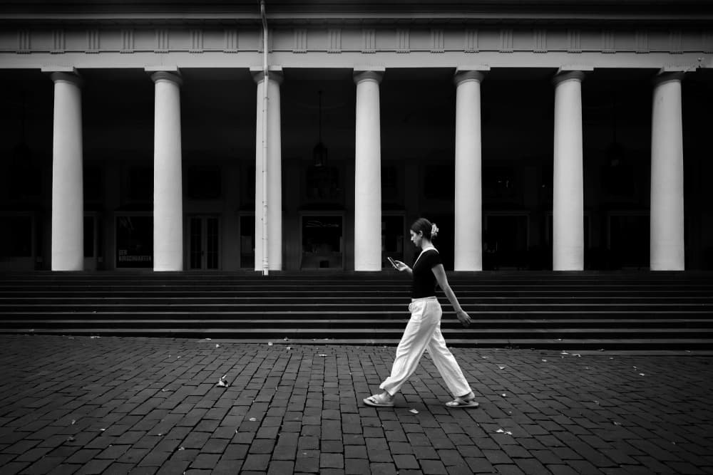 Woman Walking Grand Columns by Eiji Yamamoto — canvas wall art