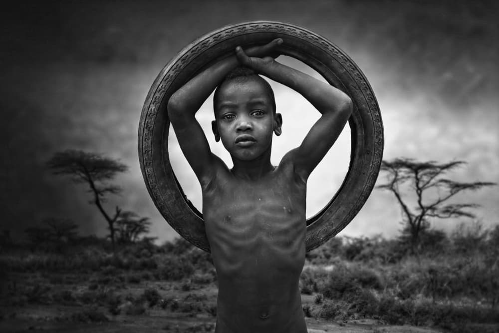 African Boy With Tire by Svetlin Yosifov — canvas wall art