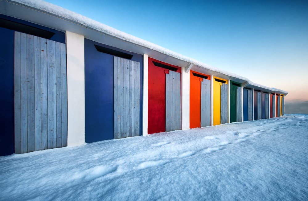 Colorful Huts in Snow by Massimo Baroni — canvas wall art