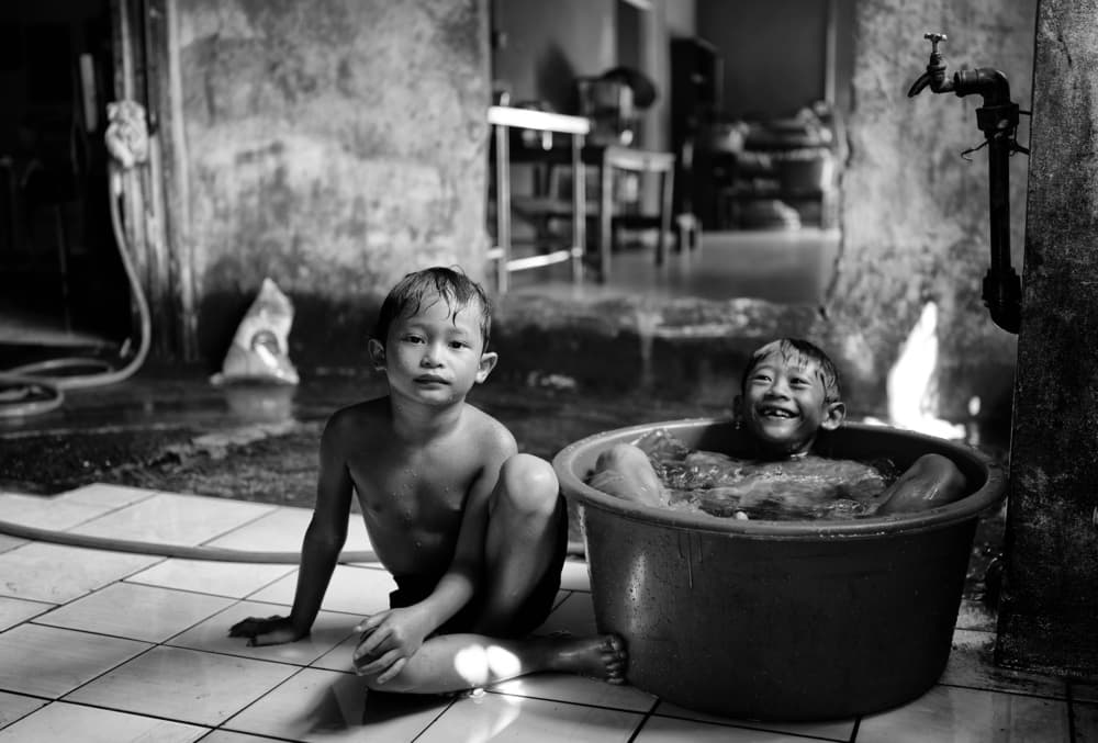 Joyful Boys Bathing by Kieron Long — canvas wall art