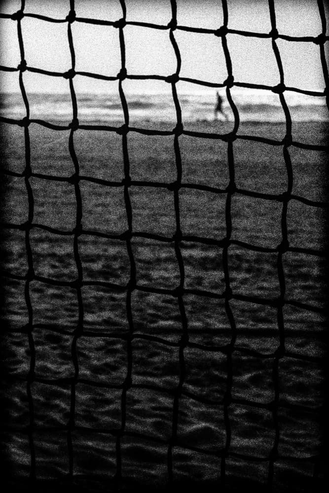 Beach Scene Through Net by Paulo Abrantes — canvas wall art