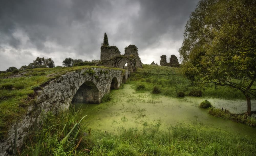 Moody Ruined Stone Bridge by Anne Berger — canvas wall art