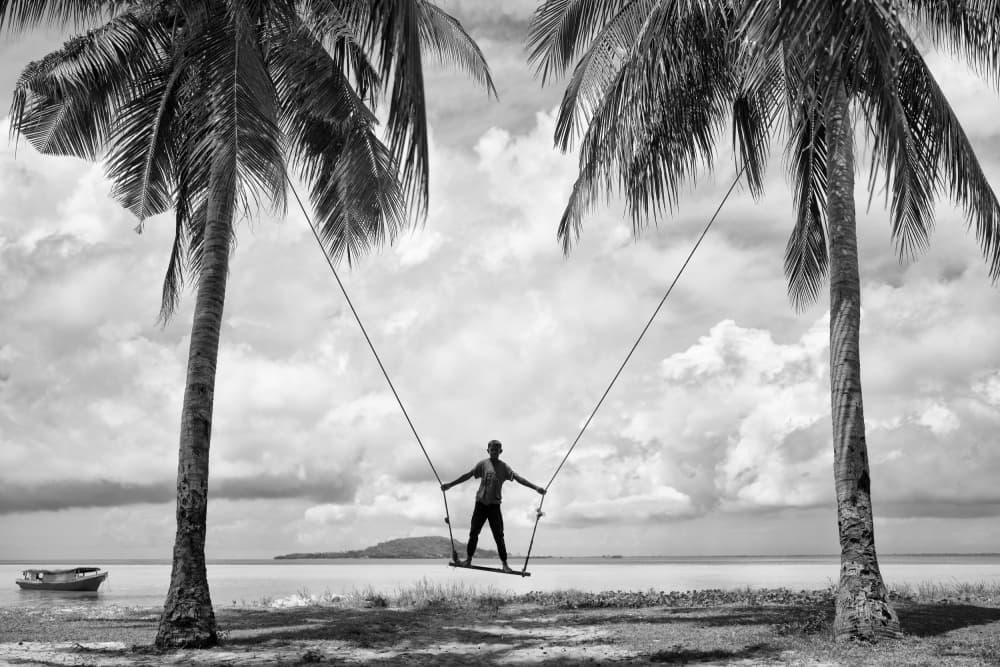 Man on Beach Swing by Kieron Long — canvas wall art