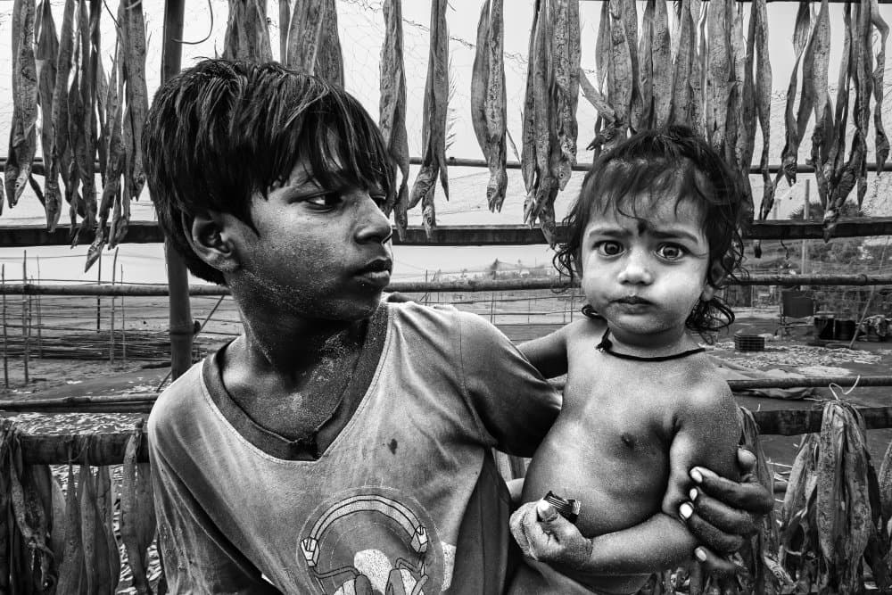 Children And Dried Fish by JOYRAJ SAMANTA — canvas wall art
