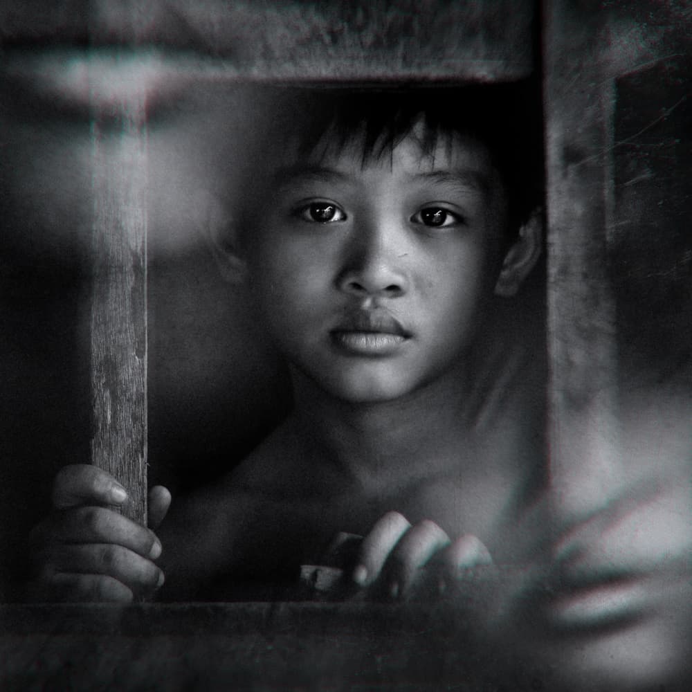 Young Boy's Pensive Gaze by Suhandi Jitir — canvas wall art