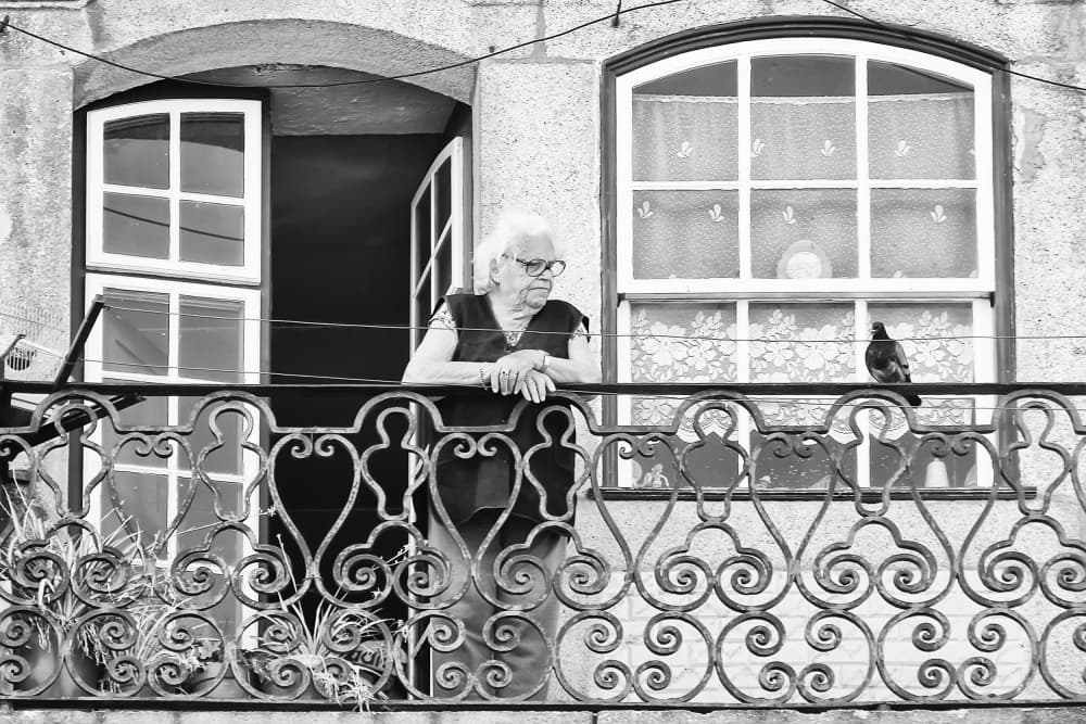 Balcony Woman and Pigeon by Josefina Melo — canvas wall art