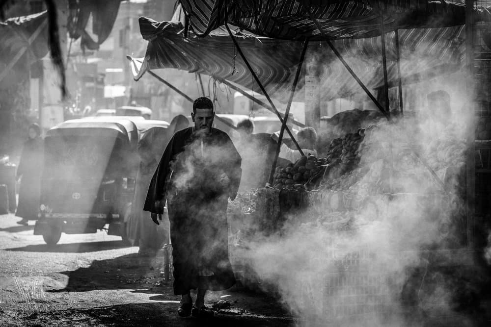 Man in Smoky Market by António Carreira — canvas wall art