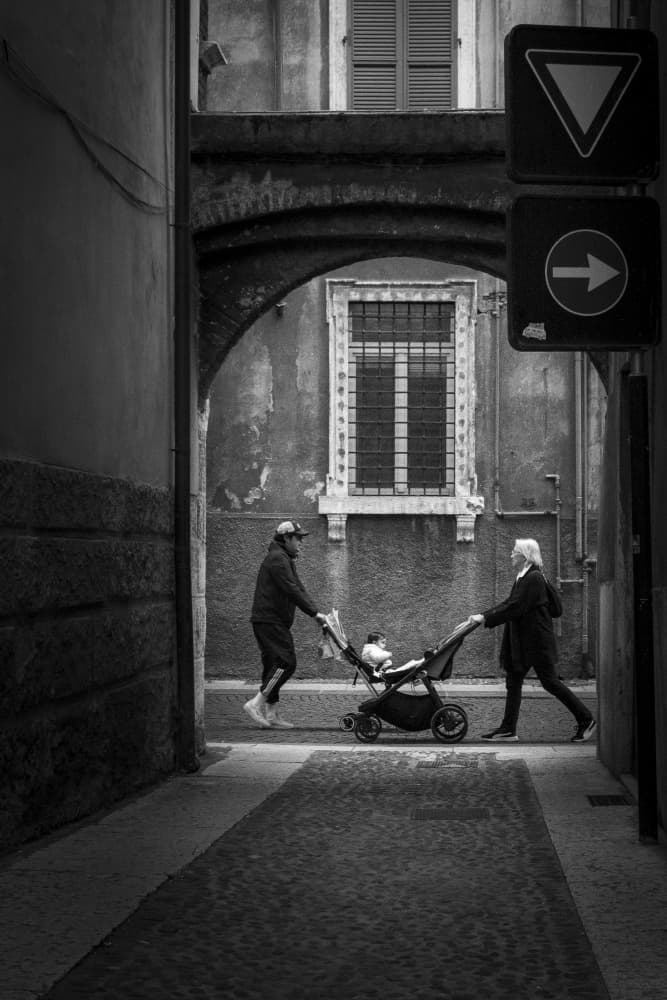 Family Stroll Through Archway by Alin Federiga — canvas wall art